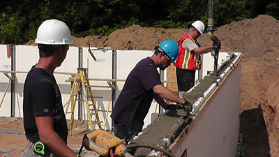 Pouring and vibrating concrete is the last step in construction your walls using ICFs 